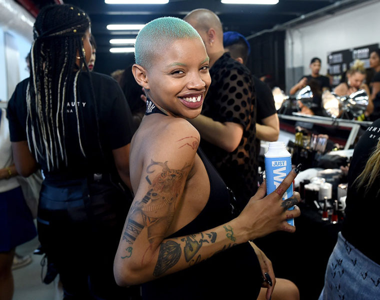 A pregnant Slick Woods back stage at a fashion show